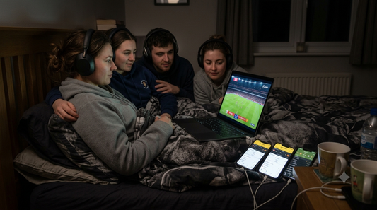 UK fan watching the 2026 FIFA World Cup in bed via free live football streams late at night.